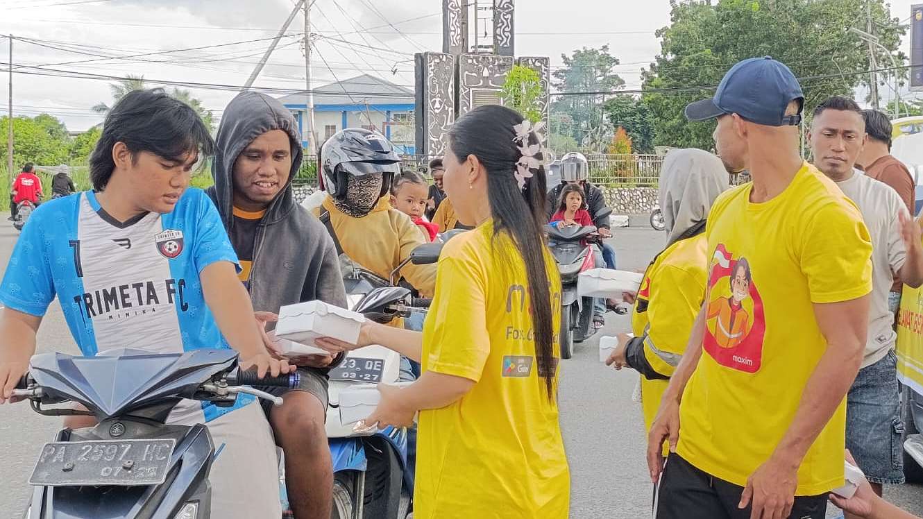 Transportasi Online Maxim bersama Persatuan Driver Maxim Timika (TMDT) membagikan 300 paket takjil kepada pengendara yang melintas di Bundaran Timika Indah, Sabtu (22/03/2025).  Foto; Martha/ Papua60detik