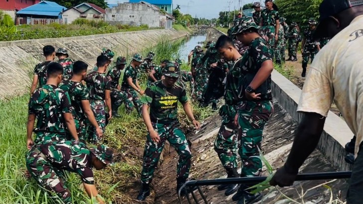 Anggota TNI membersihkan drainase di Jalan Ahmad Yani, Rabu (7/12/2022). Foto: Ami/ Papua60detik
